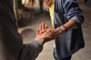 one person stretching their hand out to another